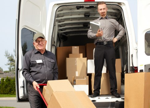 Professional movers handling office equipment