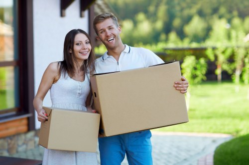 Unpackers arranging furniture in a living room